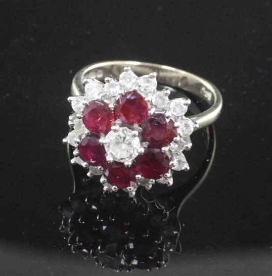 A 1970s 18ct white gold, ruby and diamond cluster ring, size N.